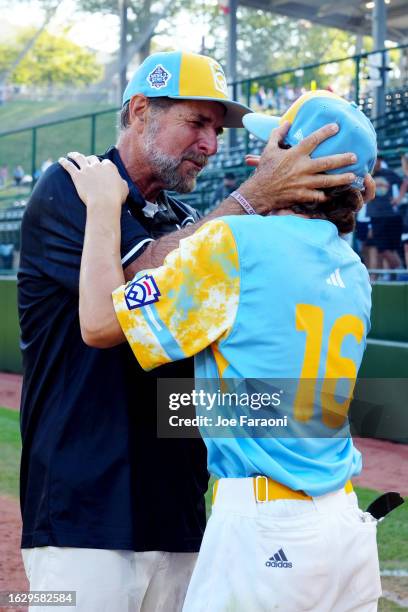 Ollie Parks of the West Region team from El Segundo, California celebrates with his coach after defeating the Caribbean Region team from Willemstad,...