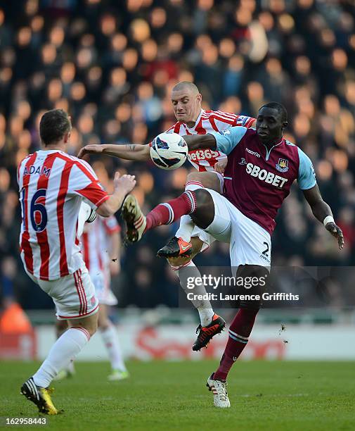 Mohamed Diame of West Ham United battles with Andy Wilkinson of Stoke City during the Barclays Premier League match between Stoke City and West Ham...