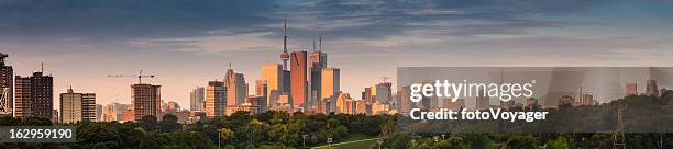 toronto downtown sunrise skyscrapers soaring over park panorama ontario canada - panoramic stock pictures, royalty-free photos & images