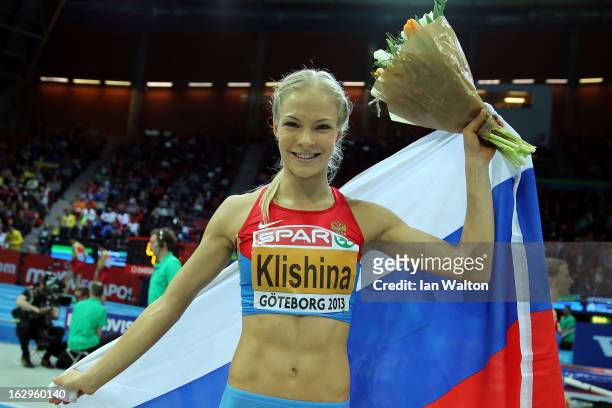 Daria Klishina of Russia celebrates winning gold in the Women's Long Jump Final during day two of the European Athletics Indoor Championships at...
