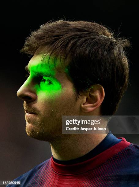 Lionel Messi of Barcelona is illuminated by laser during the la Liga match between Real Madrid CF and FC Barcelona at Estadio Santiago Bernabeu on...