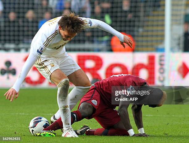 Swansea City's Spanish midfielder Miguel Michu vies with Newcastle United's Ivorian midfielder Cheick Tiote during the English Premier League...