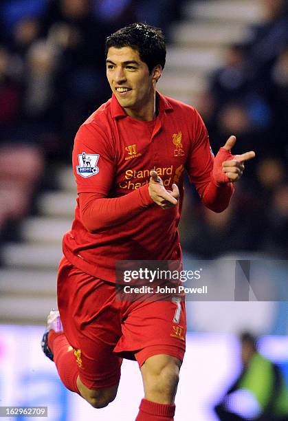 Luis Suarez of Liverpool celebrates after scoring the second goal during the Barclays Premier League match between Wigan Athletic and Liverpool at DW...