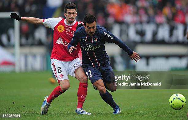 Ivan Lavezzi of Paris Saint-Germain battles with Johan Ramare of Stade de Reims Champagne celebrates victory during the Ligue 1 match between Stade...
