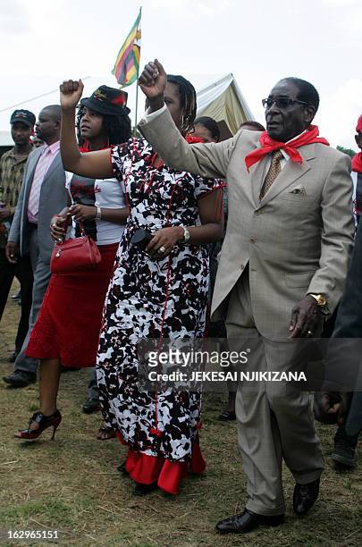 Zimbabwe's President Robert Mugabe , with wife Grace Mugabe and daughter Bona Mugabe gesture at a rally held on March 2, 2013 at Chipadze stadium in...