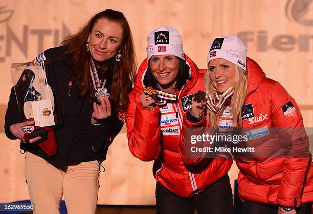 Marit Bjoergen of Norway poses with her Gold medal on the podium with Silver medalist Justyna Kowalczyk of Poland and Bronze medalist Therese Johaug...
