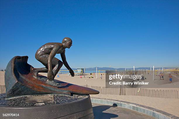 surfer statue on beach. - hermosa beach stock pictures, royalty-free photos & images