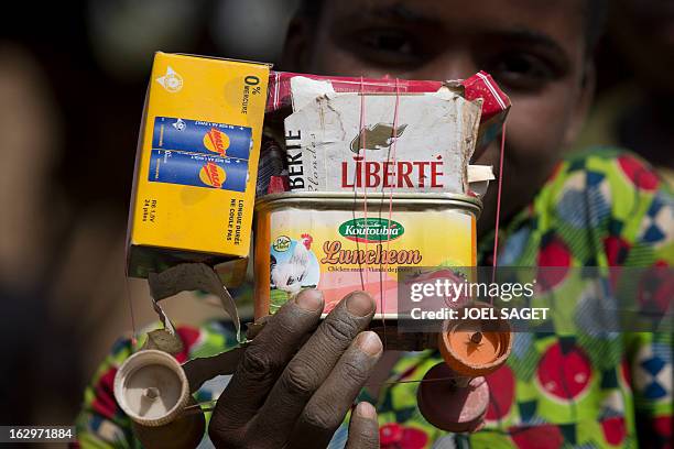 Boy holds a homemade toy car in Bore, near Mopti, on March 2, 2013. French and Malian troops have been pushing back armed Islamist militant groups...