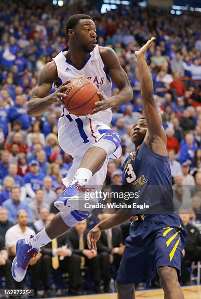 Kansas guard Elijah Johnson looks for an outlet under the basket during first-half action in against West Virginia at Allen Fieldhouse in Lawrence,...