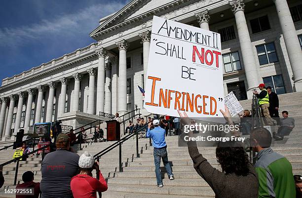 Gun rights supporters hold signs and listen to former Republican congressional candidate from Utah, Mia Love, speak at a gun rights rally and march...