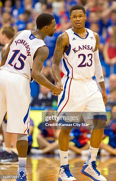 Kansas Jayhawks guard Elijah Johnson congratulates teammate Ben McLemore as he leaves the game with 36 points against the West Virginia Mountaineers...