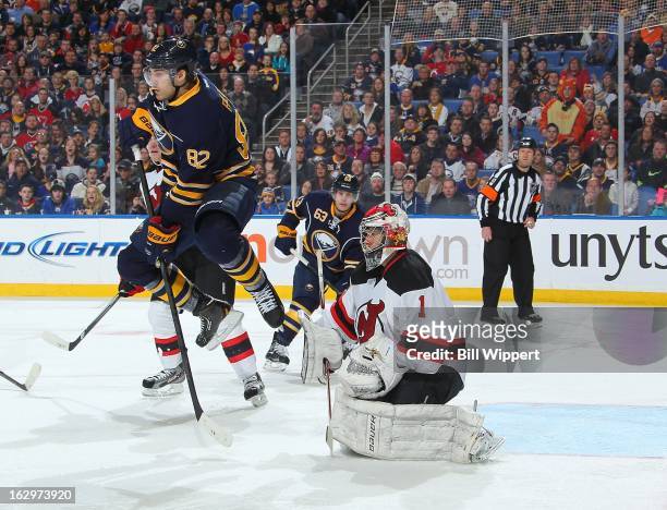 Marcus Foligno of the Buffalo Sabres leaps in the air in an attempt to screen Johan Hedberg of the New Jersey Devils on March 2, 2013 at the First...