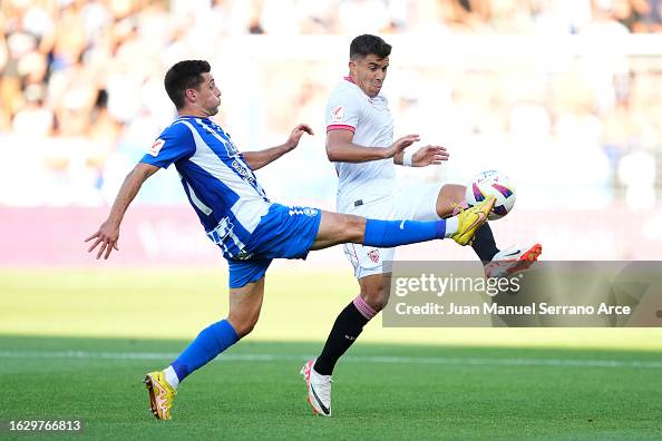 Marcos Acuna of Sevilla battles for possession with Xeber Alkain
