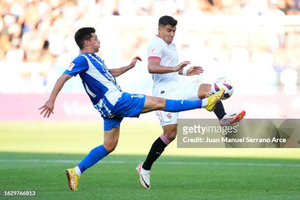 Marcos Acuna of Sevilla battles for possession with Xeber Alkain of Deportivo Alaves during the LaLiga EA Sports match between Deportivo Alaves and...