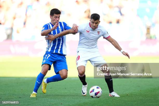 Marcos Acuna of Sevilla battles for possession with Xeber Alkain