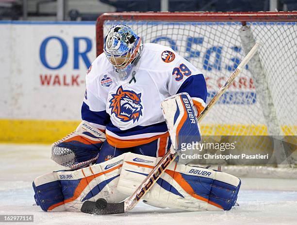 Rick DiPietro of the Bridgeport Sound Tigers makes a save prior to an American Hockey League game against the Adirondack Phantoms on March 2, 2013 at...