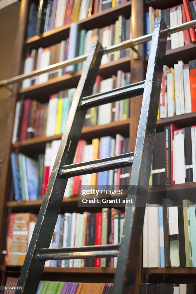 Ladder leaning on bookshelves in a bookshop.