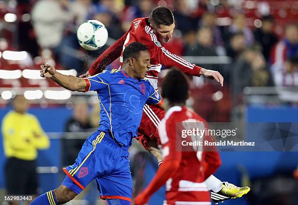 Diego Calderon of the Colorado Rapids jumps for a header against Kenny Cooper of FC Dallas at FC Dallas Stadium on March 2, 2013 in Frisco, Texas.