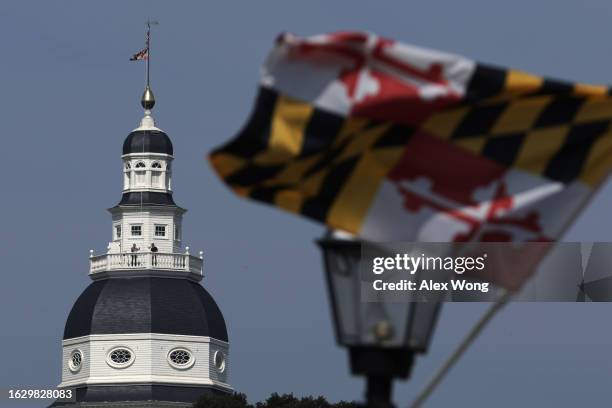 As a Maryland State flag flies in the foreground, the Maryland State House is seen on August 21, 2023 in Annapolis, Maryland. The Maryland State...