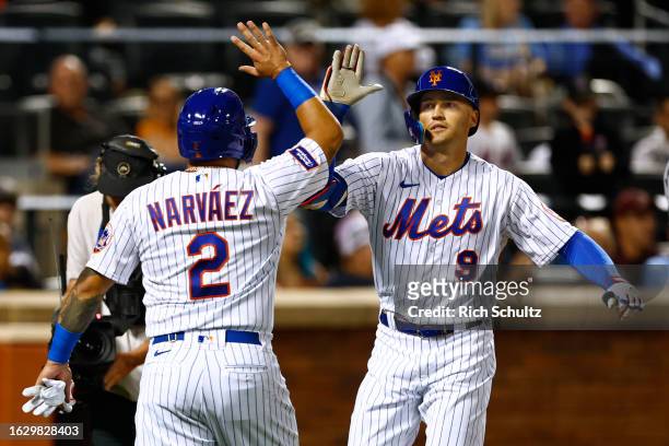 Brandon Nimmo of the New York Mets is congratulated by Omar Narvaez after hitting a two-run home run against the Texas Rangers during the third...