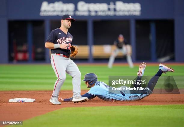 George Springer of the Toronto Blue Jays steals second base against Jake Alu of the Washington Nationals during the first inning at the Rogers Centre...