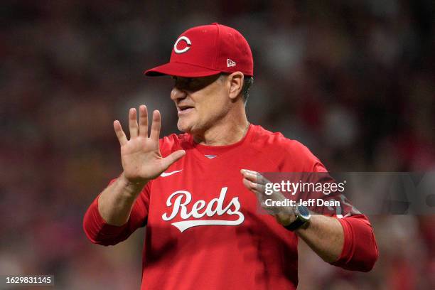 David Bell of the Cincinnati Reds speaks with the home plate umpire during a baseball game against the Toronto Blue Jays at Great American Ball Park...