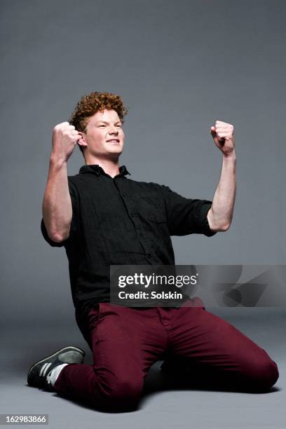 young man in victory pose, studio background - happy fans stock pictures, royalty-free photos & images