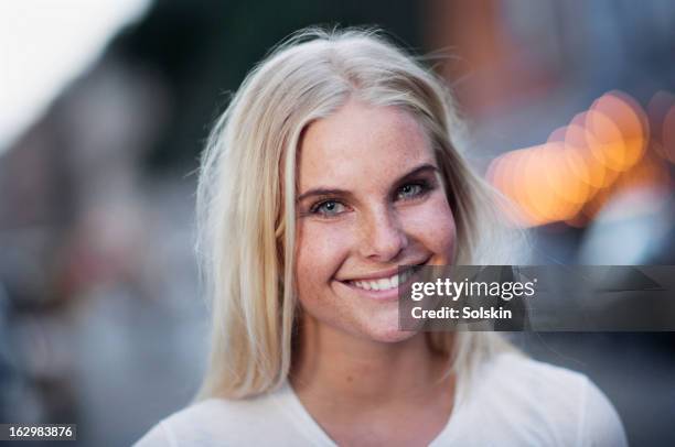 portrait of young woman, city background - scandinavian woman blond stock pictures, royalty-free photos & images