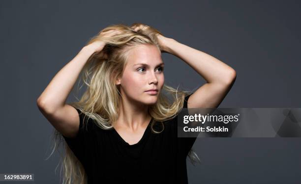 woman holder hands to her head, studio background - scandinavian woman blond stock pictures, royalty-free photos & images