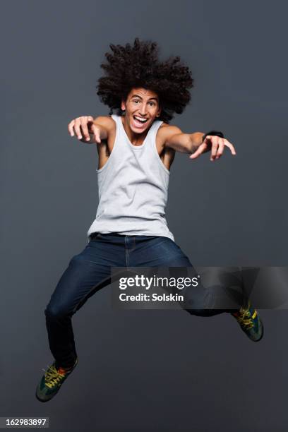 young man jumping, studio background - man skinny jeans stock pictures, royalty-free photos & images