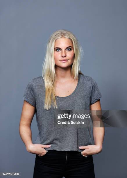 portrait of young woman, studio background - satisfaction stock pictures, royalty-free photos & images