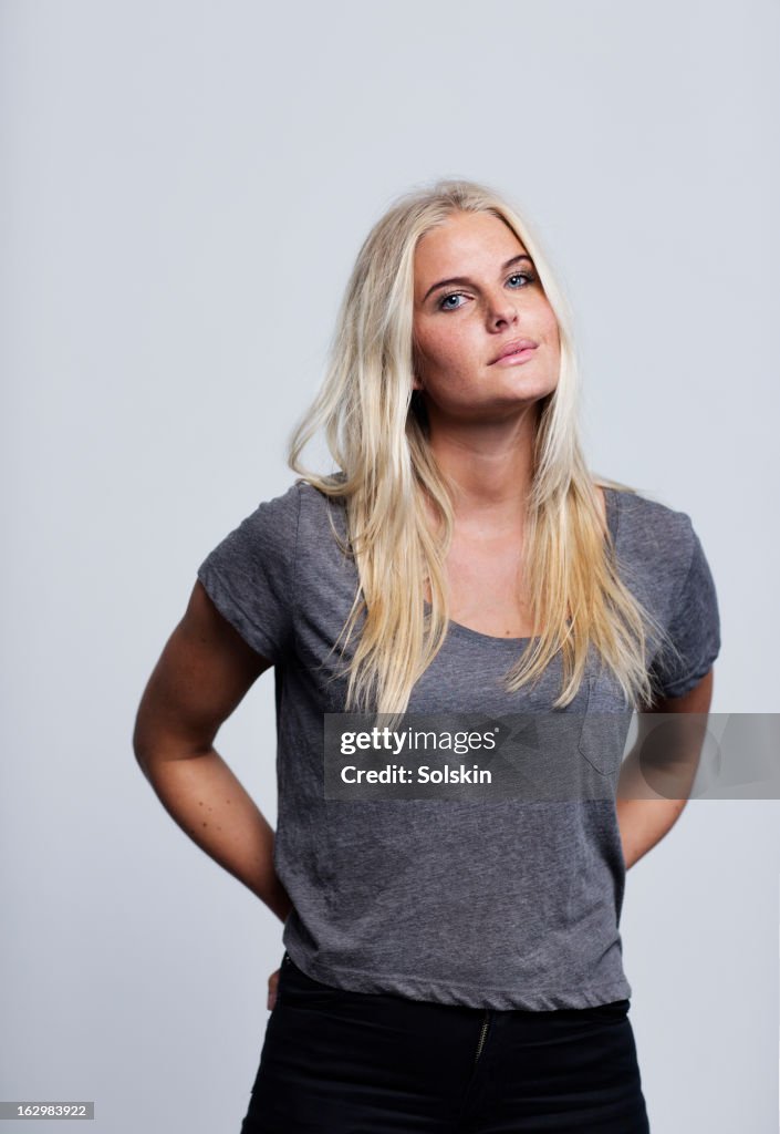 Portrait of young woman, studio background