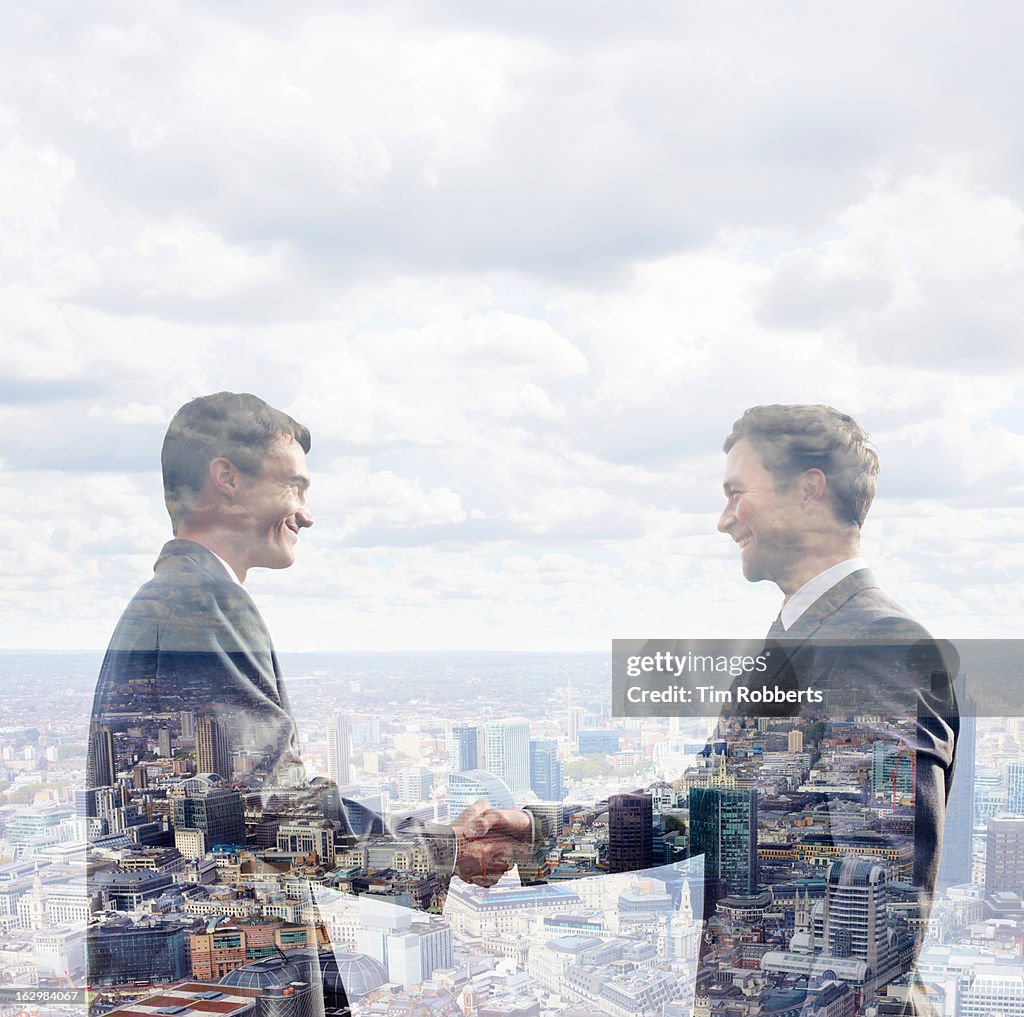 Two business men shaking hands.