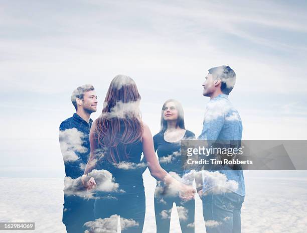 four friends holding hands with clouds. - cult stock pictures, royalty-free photos & images