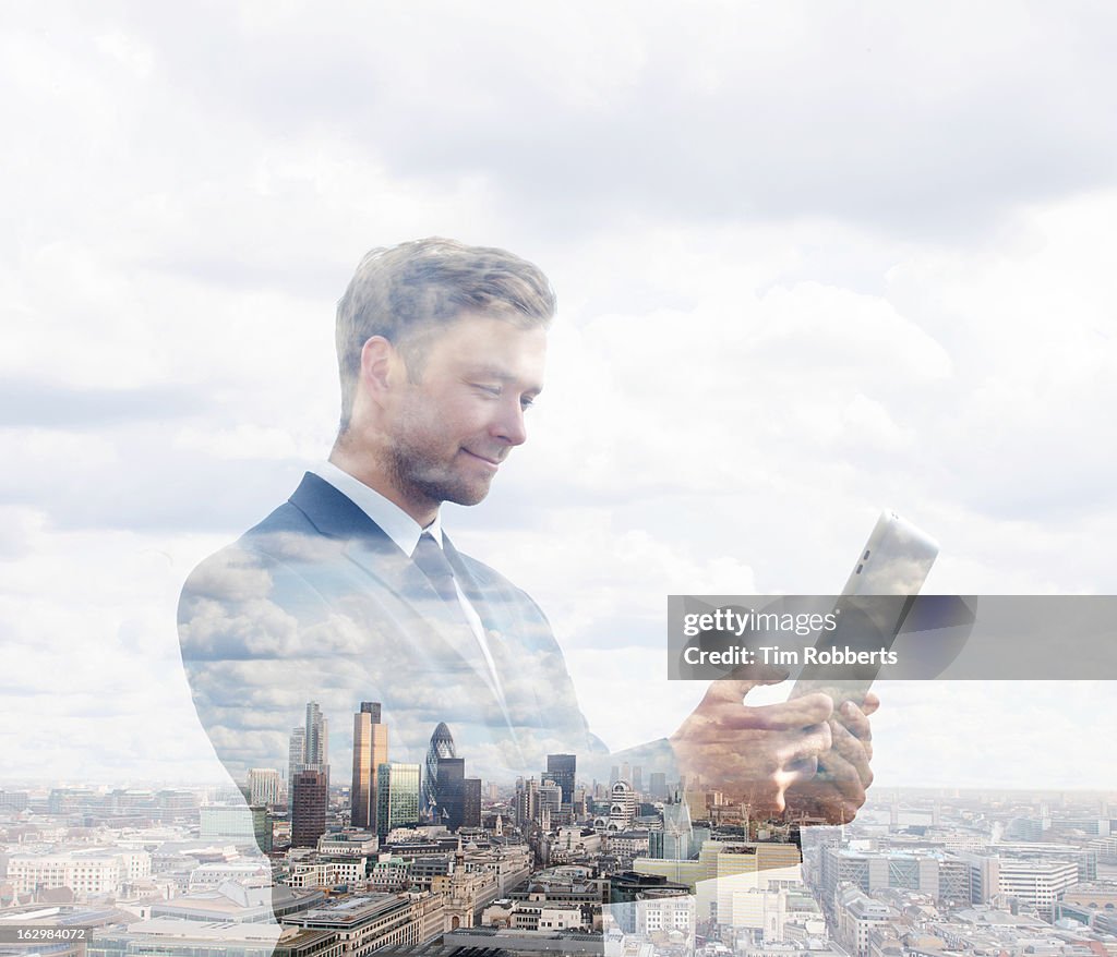 Business man using tablet with London view.