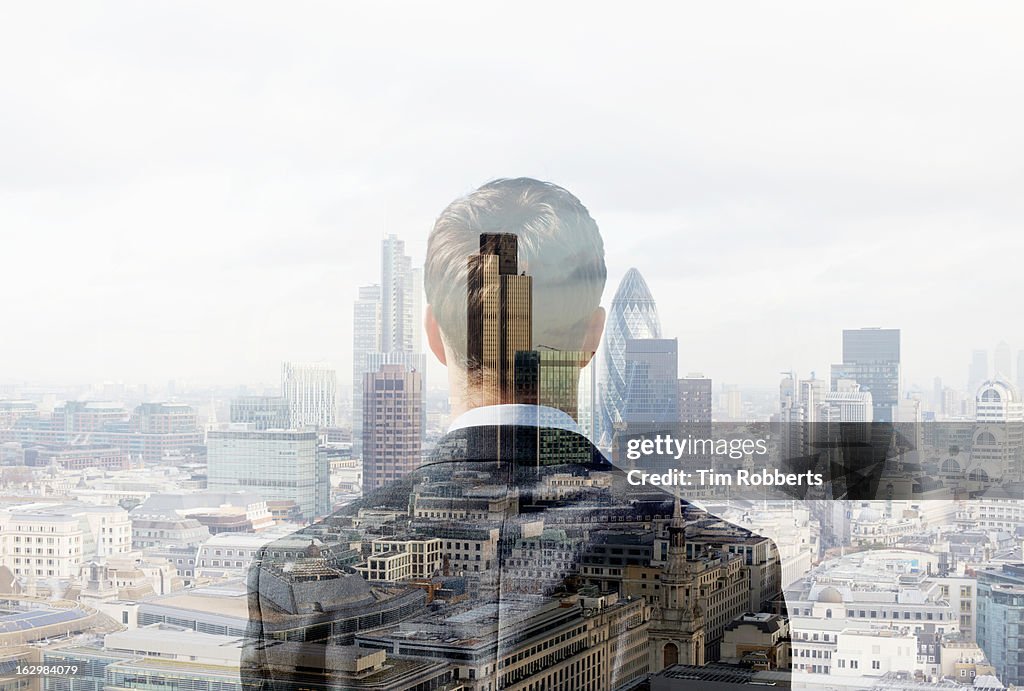 Business man looking towards the city.