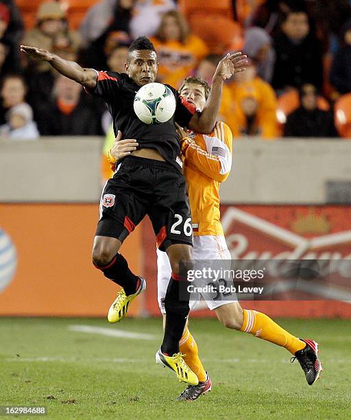 Lionard Pajoy of D.C. United chests the ball down as Bobby Boswell of the Houston Dynamo applies pressure during second half action at BBVA Compass...