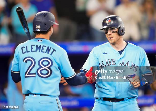 Danny Jansen (RR of the Toronto Blue Jays celebrates his home run with Ernie Clement during the third inning against the Washington Nationals at the...