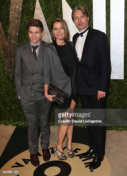 Actor Mads Mikkelsen poses with son Carl Mikkelsen and wife Hanne Jacobsen at the 2013 Vanity Fair Oscar Party at the Sunset Tower Hotel on February...