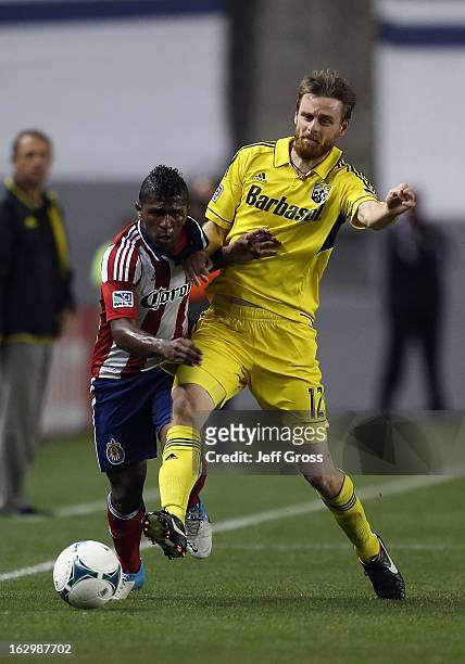 Miller Bolanos of Chivas USA and Eddie Gaven of Columbus Crew fight for the ball in the second half at The Home Depot Center on March 2, 2013 in...