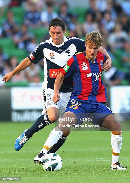 Mark Milligan of the Victory and Adam Taggart of the Jets contest for the ball during the round 23 A-League match between the Melbourne Victory and...