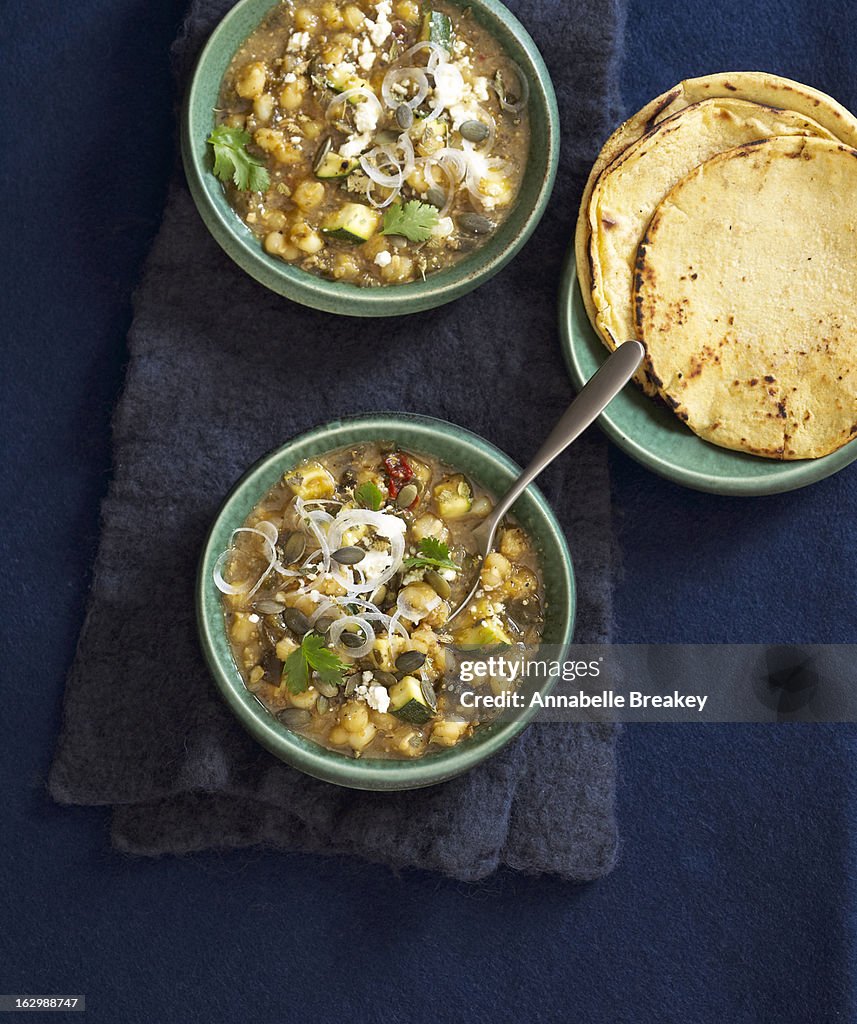 Bowl of Mexican stew with tortillas