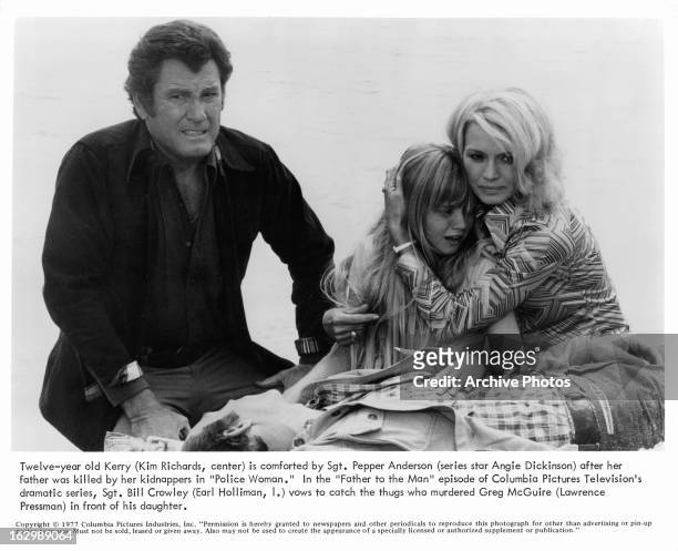 Earl Holliman crouches over the body of Lawrence Pressman while Kim Richards cries and Angie Dickinson holds her in a scene from the television...