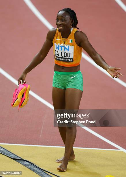 Marie-Josee Ta Lou of Team Ivory Coast reacts in the Women's 100m Semi-Final during day three of the World Athletics Championships Budapest 2023 at...