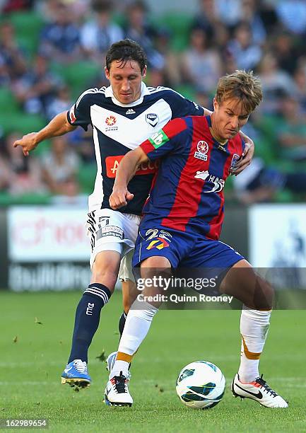 Mark Milligan of the Victory and Adam Taggart of the Jets contest for the ball during the round 23 A-League match between the Melbourne Victory and...