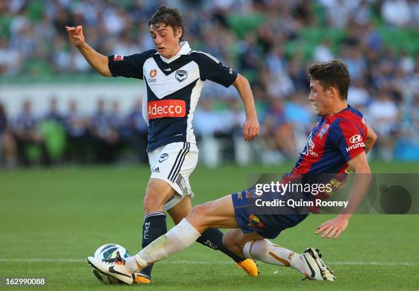 Marco Rojas of the Victory is tackled by Scott Neville of the Jets during the round 23 A-League match between the Melbourne Victory and the Newcastle...