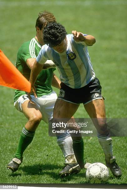 Diego Maradona of Argentina takes on Thomas Berthold of West Germany during the World Cup final at the Azteca Stadium in Mexico City. Argentina won...