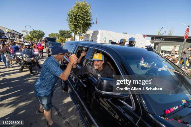 El Segundo, CA El Segundo Little League All Stars Manager Danny Boehle gets congratulated by a fan as he and the team celebrate with a large crowd of...