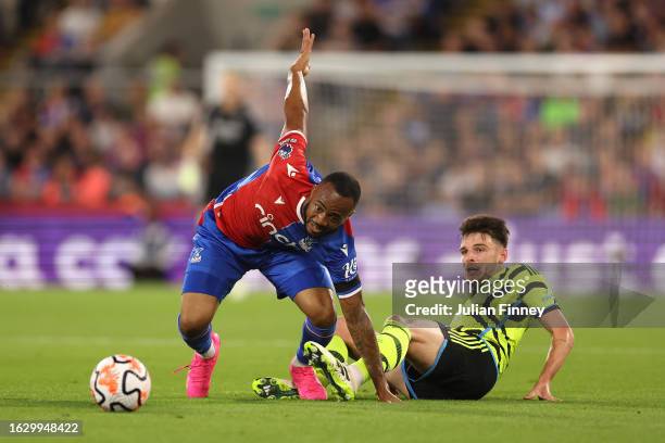 Jordan Ayew of Crystal Palace is tackled by Declan Rice of Arsenal during the Premier League match between Crystal Palace and Arsenal FC at Selhurst...