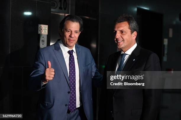 Fernando Haddad, Brazil's finance minister, left, greets Sergio Massa, Argentina's economy minister and presidential candidate of Unity for the...